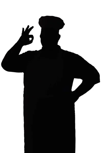 Silhouette d'un chef heureux sur un fond blanc isolé, la main masculine montre ok — Photo