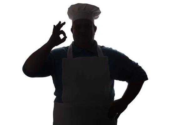 Silueta de un chef feliz sobre un fondo blanco aislado, mano masculina muestra ok — Foto de Stock