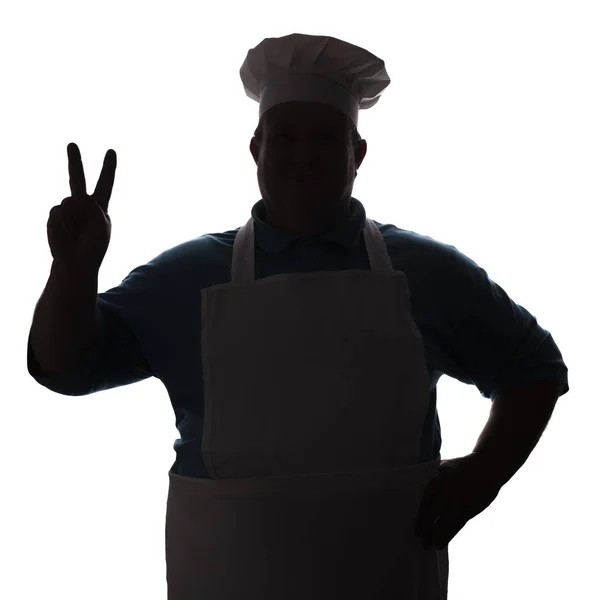 Silhouette dell'uomo in abiti da cucina, chef mostra un gesto di saluto con le dita su sfondo bianco isolato, concetto di professione — Foto Stock