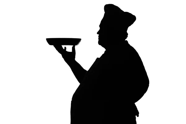在白色孤立的背景上，一个首席炊具配置文件的剪影，人携带的菜服务 — 图库照片