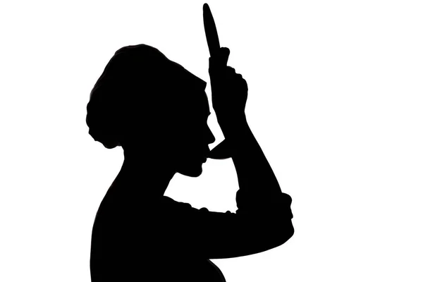 女人在帽子里做饭的剪影, 一个女孩的轮廓从一个白色的孤立背景的钢包上品尝汤 — 图库照片