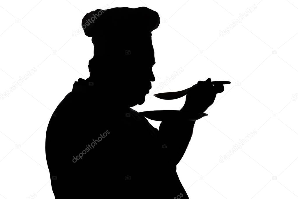 silhouette of a chief-cooker tasting dish on a white isolated background, profile of a male face in a cook hat