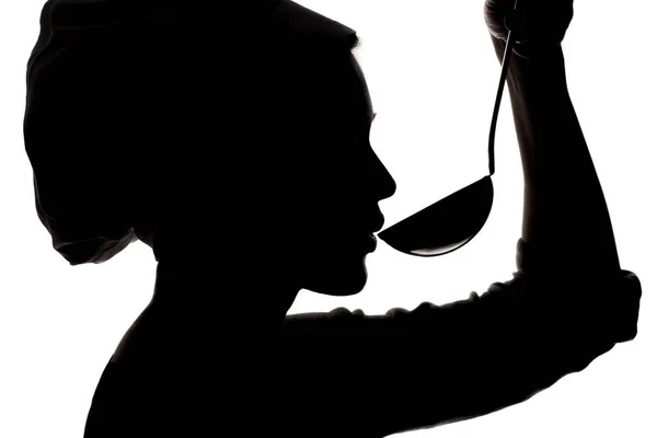 Bir kap içinde profil bir kızın yemek kadın silüeti ona Kepçe beyaz izole arka planda üzerinde üfleme çorba titreme — Stok fotoğraf