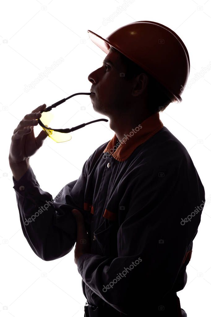 silhouette of a construction worker dreaming of a career, a man in a helmet on a white isolated background