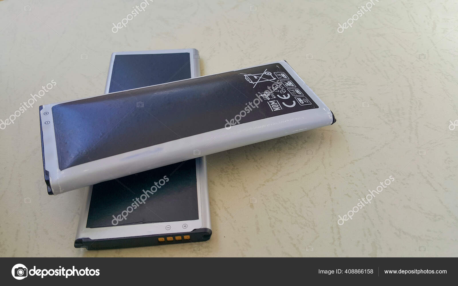 Two Close Batteries One Regular Other Swollen Lithium Ion