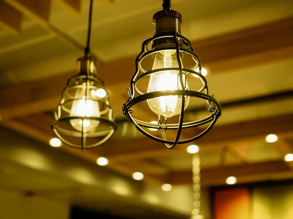 Close up of exposed light bulbs  in metal cages glowing with sof