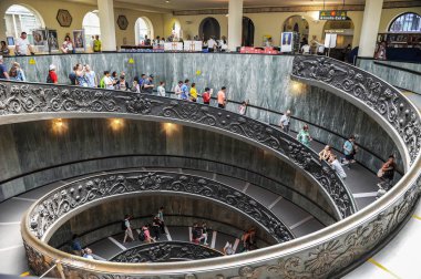 Vatican - August 2017: The modern 'Bramante' spiral stairs of the Vatican Museums, designed by Giuseppe Momo in 1932  clipart