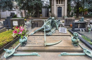 Milan, Italy - December 2017: art tombstone at the city Monumental cemetery clipart
