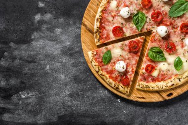 İtalyan pizza dilim domates, peynir ve siyah taş fesleğen ile. Üstten görünüm. Boşaltmak