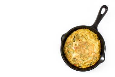 Yumurta ve beyaz arka plan üzerinde izole sebzeler demir tavada frittata yapmış. Üstten görünüm. Boşaltmak