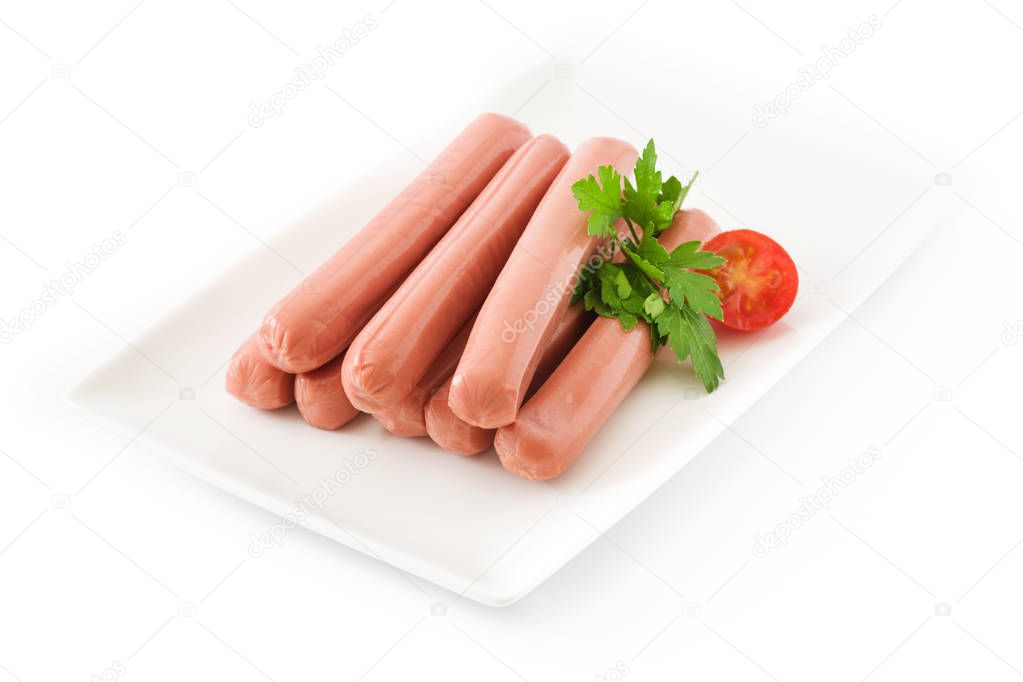 Raw sausages in a white plate isolated on white background