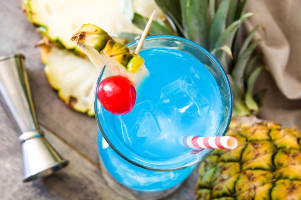 Blue Hawaiian cocktail on wooden table.