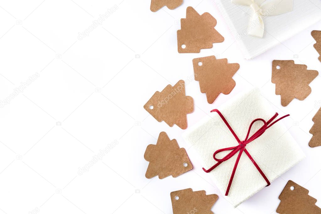 White gift box and christmas tree label on white background. Top view. Copyspace