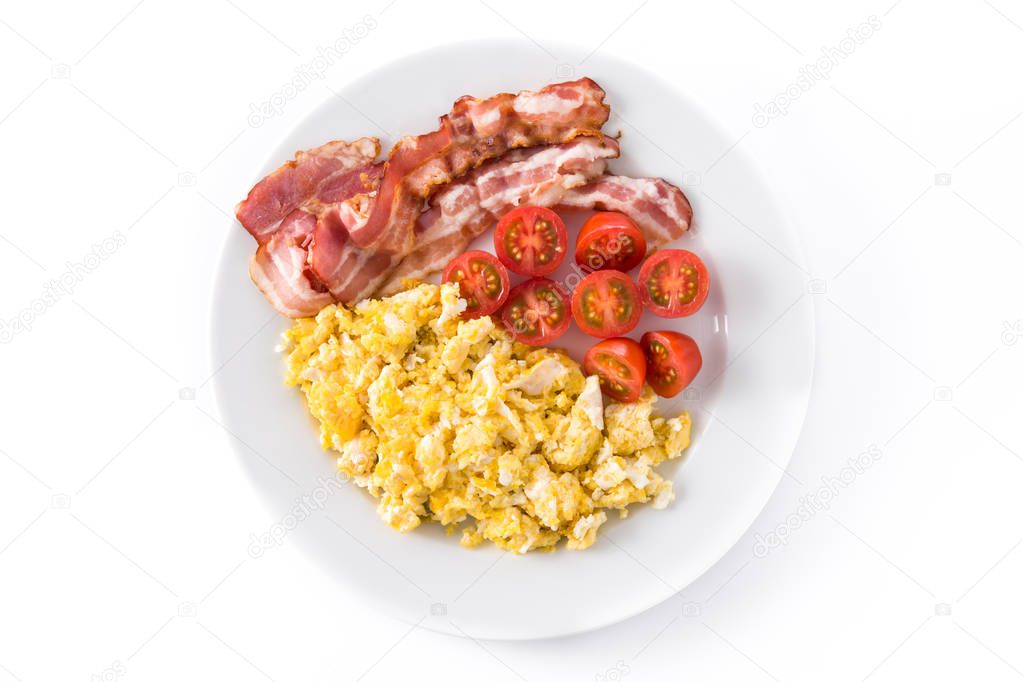 Breakfast with scrambled eggs, bacon and tomatoes isolated on white background. Top view