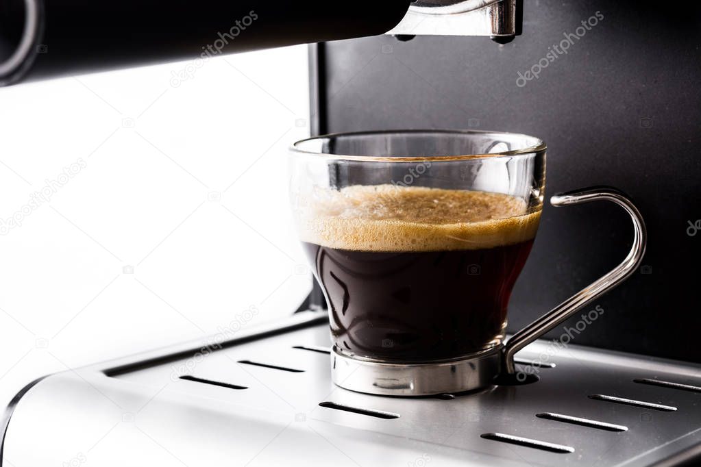fresh coffee in espresso coffee machine isolated on white background