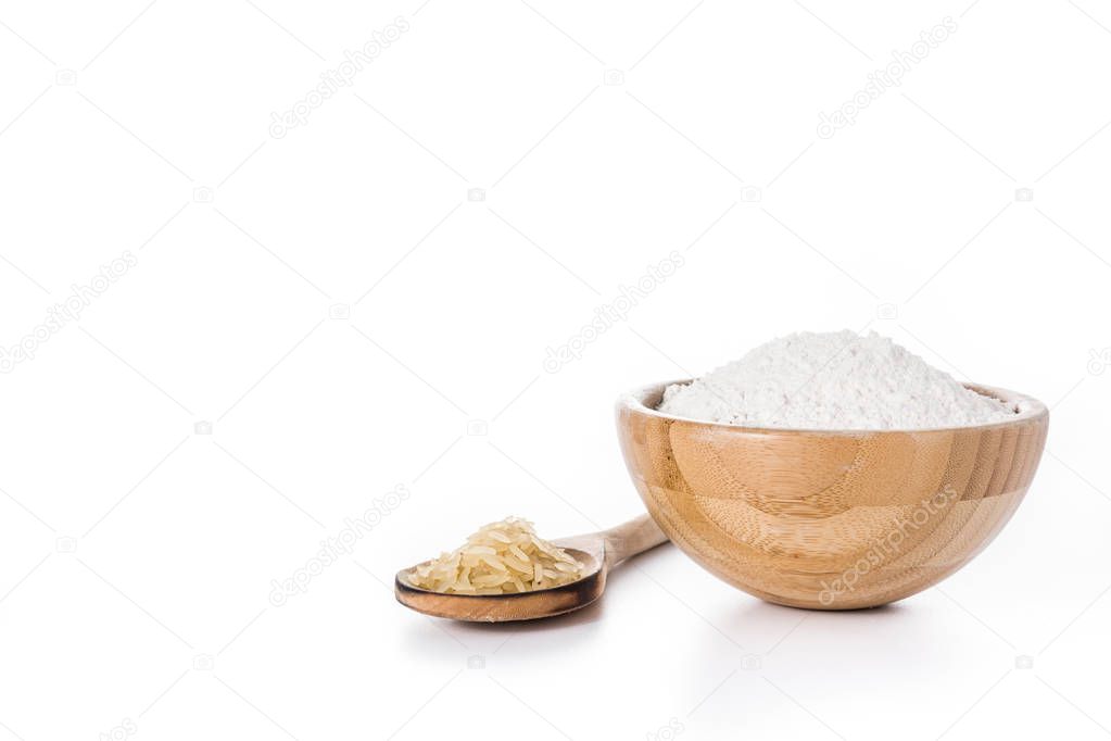 White rice flour in a bowl isolated on white background. Copyspace