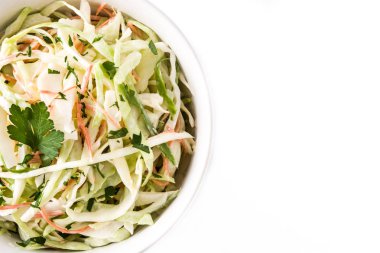 Coleslaw salad in white bowl isolated on white background. Top view. Copyspace