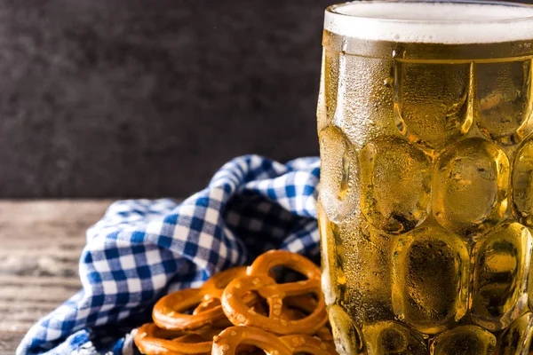 Oktoberfest beer and pretzel on wooden table. Copyspace