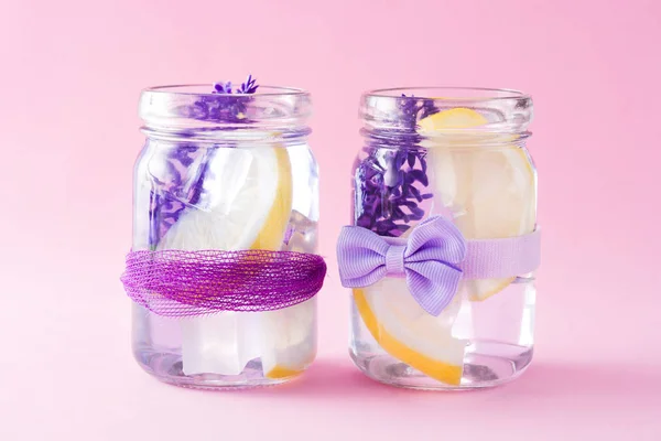 Lavender lemonade drink on pink background.