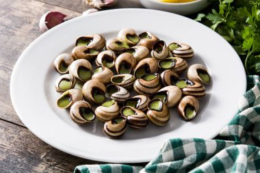 Escargots de Bourgogne on wooden table