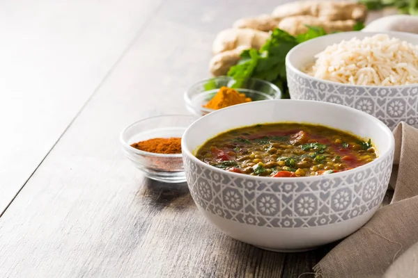 Indian lentil soup dal (dhal) in a bowl on wooden table. Copyspace