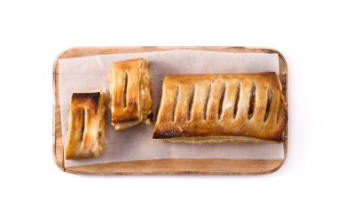 Traditional homemade apple strudel slice isolated on white background. Top view. 