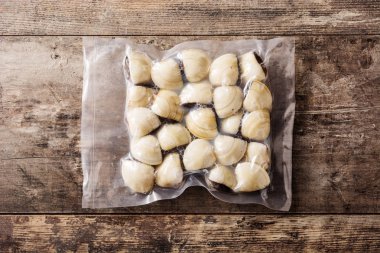 İstiridyeler ahşap masada plastik içinde paketlenmiş. Üst görünüm