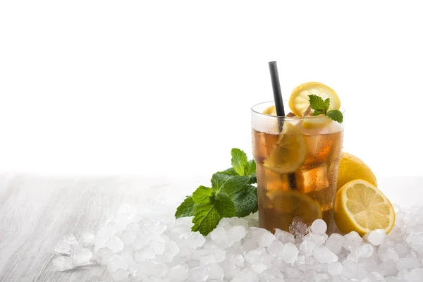 Iced tea drink with lemon in glass and ice on white wooden table.Copy space