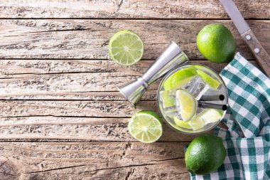 Ahşap masada limonlu Caipiroska kokteyli. Üst Manzara. Boşluğu kopyala