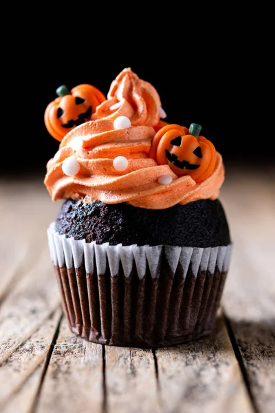 Kabak süslemeli Cadılar Bayramı çörekleri kırsal ahşap masa ve siyah arka plan. 