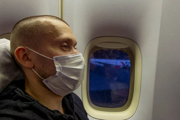 Ein Männlicher Passagier Mit Medizinischer Maske Bord Des Flugzeugs Geht Stockfoto