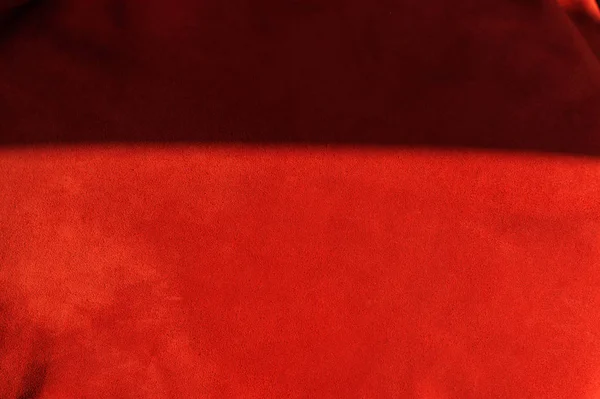 Ciemnoczerwone matowe tło z zamszu tkaniny, zbliżenie. Aksamitna faktura bezszwowej skóry winnej. — Zdjęcie stockowe