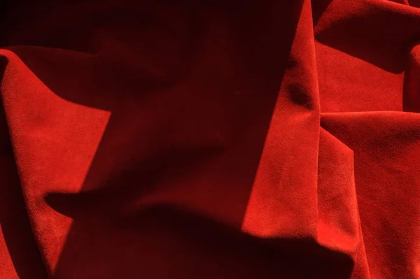 Dark red matte background of suede fabric, closeup. Velvet texture of seamless wine leather. — Stock Photo, Image