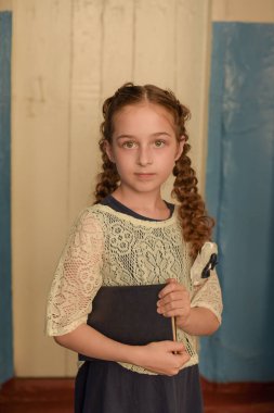 Okula ve eğitim anlayışına geri dönelim. Kız büyük açık kitap tutar. Bazı fikir düşünme sürpriz yüz ile Okul kız.