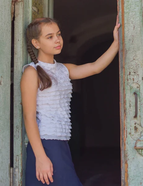 Close up portrait of little beautiful stylish kid girl near red brick wall as background — Stock Photo, Image