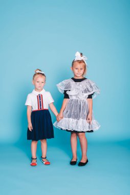 Okula geri dön. Mavi arka planda iki kız öğrenci