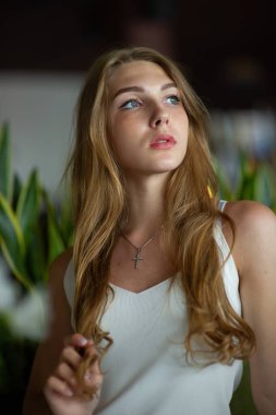 Mavi gözlü bir kız şehir kafede oturuyor. kahverengi dalgalı saç modeli ile kadın. Yaşam tarzı kavramı.