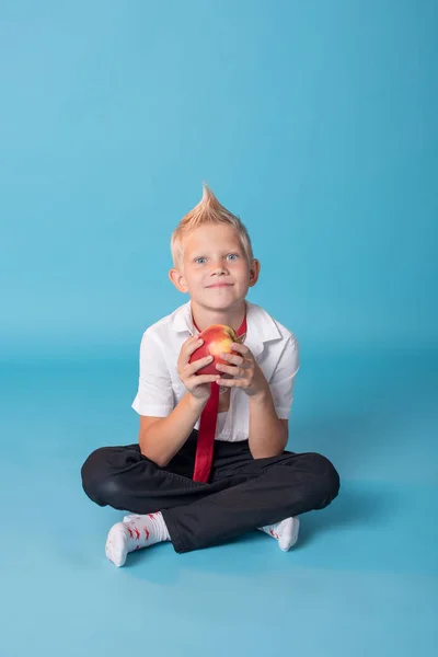 Close-up of a blond boy.The boy is posing on the camera.