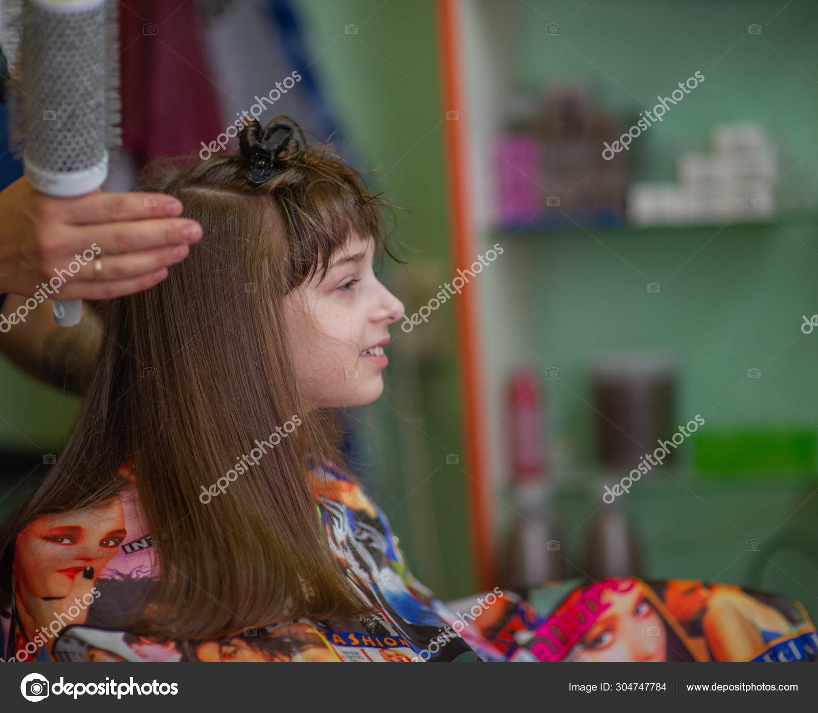 Stylist Hairdresser Makes A Hairstyle For A Cute Little Girl In A