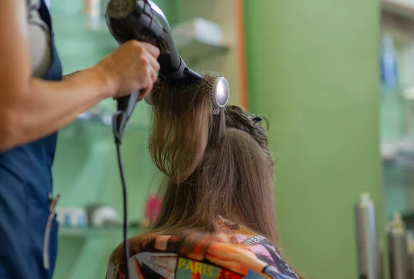 Stylist Friseur macht eine Frisur für ein nettes kleines Mädchen in einem Schönheitssalon. Friseur, Haarschnitt. — Stockfoto