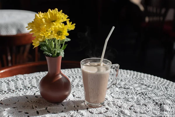 Glass of tasty chocolate milk on wooden table, space for text. Dairy drink