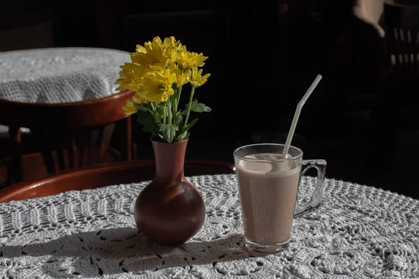 Glass of tasty chocolate milk on wooden table, space for text. Dairy drink