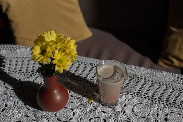 Glass of tasty chocolate milk on wooden table, space for text. Dairy drink