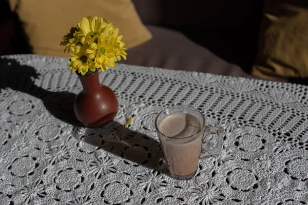 Glass of tasty chocolate milk on wooden table, space for text. Dairy drink