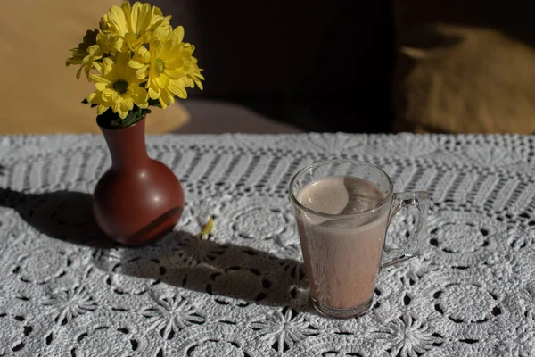 Glass of tasty chocolate milk on wooden table, space for text. Dairy drink