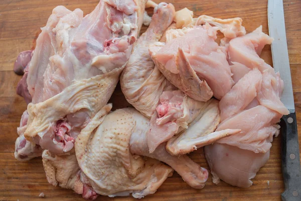 Frango inteiro cru orgânico em fundo rústico de madeira — Fotografia de Stock