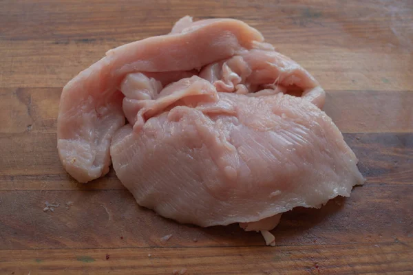 Fresh chicken meat on wooden board on table . Selective focus. Rustic style. — Stock Photo, Image