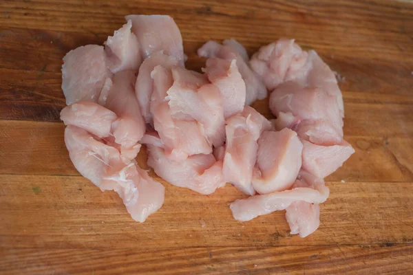 Fresh chicken meat on wooden board on table . Selective focus. Rustic style. — Stock Photo, Image