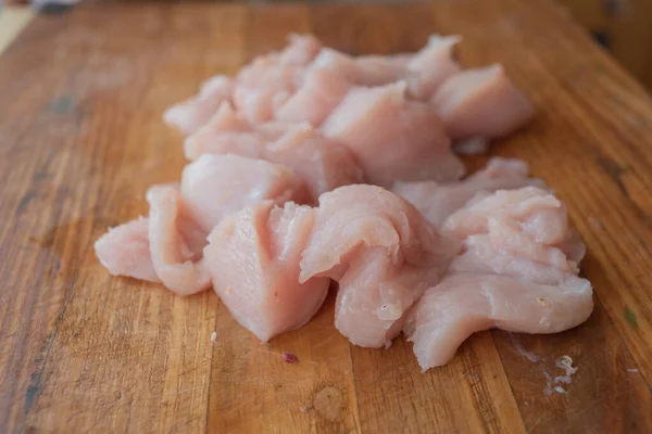Fresh chicken meat on wooden board on table . Selective focus. Rustic style.