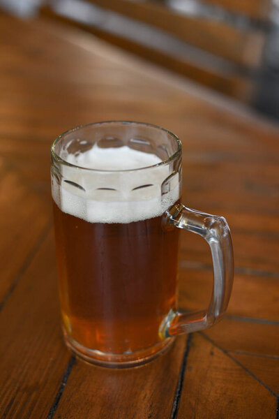 Glass of beer on wooden table. Beer in a glass